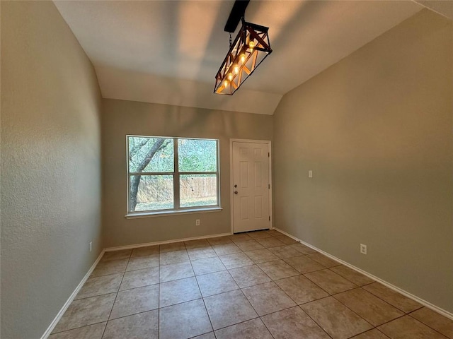 2009 Meadow View Dr, San Marcos, TX 78666 - unfurnished room with light tile patterned floors, lofted ceiling, and baseboards