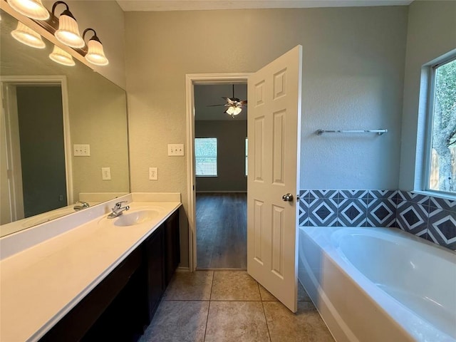 2009 Meadow View Dr, San Marcos, TX 78666 - bathroom with a garden tub, tile patterned flooring, vanity, and healthy amount of natural light
