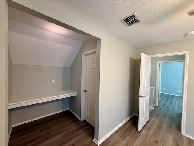 2009 Meadow View Dr, San Marcos, TX 78666 - additional living space with dark wood-style floors, a textured ceiling, baseboards, and vaulted ceiling