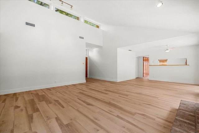 4831 Trail Crest Cir, Austin, TX 78735 - empty room with light wood-type flooring, ceiling fan, baseboards, and high vaulted ceiling