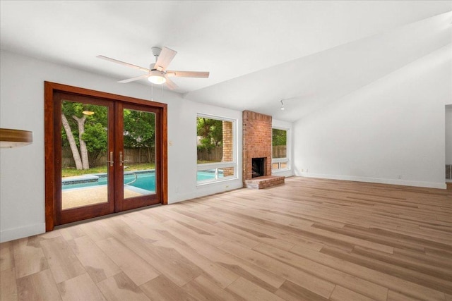 4831 Trail Crest Cir, Austin, TX 78735 - unfurnished living room with french doors, plenty of natural light, light wood-style floors, baseboards, and vaulted ceiling