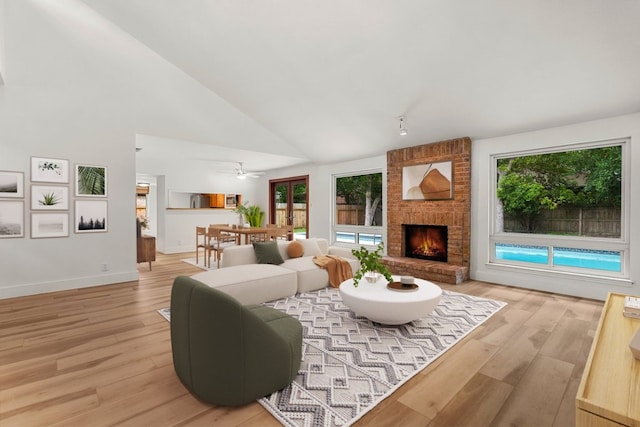 4831 Trail Crest Cir, Austin, TX 78735 - living area with light wood-style floors, a brick fireplace, high vaulted ceiling, baseboards, and ceiling fan