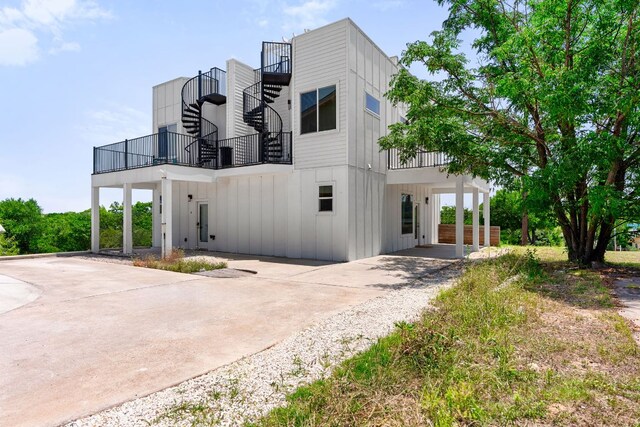 2108 Rosewood Ave Unit A, Austin, TX 78702 - view of front of property featuring board and batten siding, a balcony, driveway, and a carport