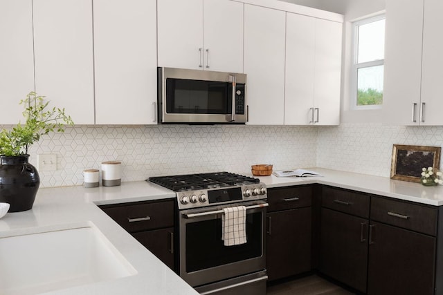 2108 Rosewood Ave Unit A, Austin, TX 78702 - kitchen featuring stainless steel appliances, light countertops, white cabinets, backsplash, and a sink
