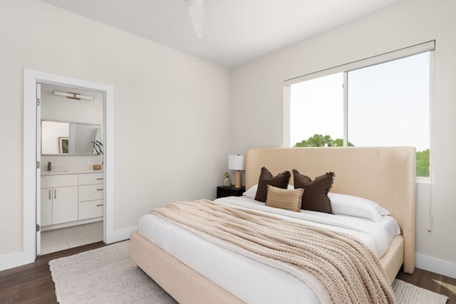2108 Rosewood Ave Unit A, Austin, TX 78702 - bedroom featuring wood finished floors, ensuite bath, and baseboards