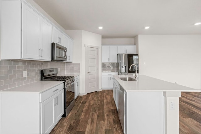 117 Scarborough Way, San Marcos, TX 78666 - kitchen with appliances with stainless steel finishes, a sink, dark wood-type flooring, light countertops, and recessed lighting