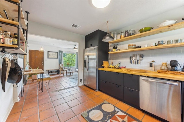 3409 Kay St, Austin, TX 78702 - kitchen featuring stainless steel appliances, dark cabinets, wooden counters, backsplash, and open shelves