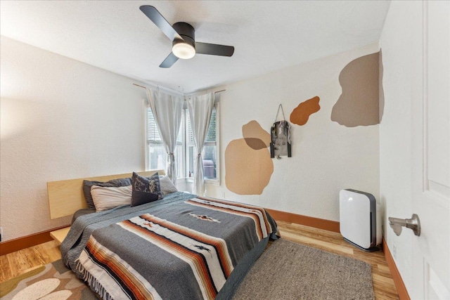 3409 Kay St, Austin, TX 78702 - bedroom with wood finished floors, ceiling fan, and baseboards