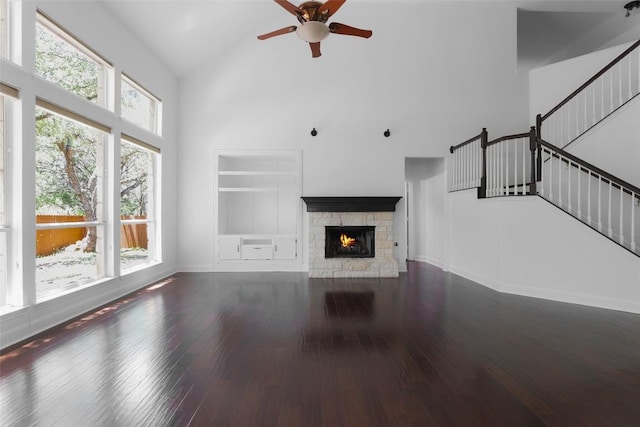 7921 Davis Mountain Pass, Austin, TX 78726 - unfurnished living room featuring high vaulted ceiling, healthy amount of natural light, ceiling fan, wood finished floors, and stairway