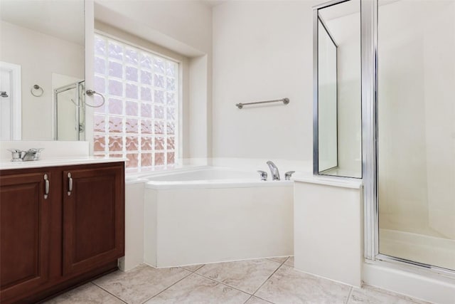 7921 Davis Mountain Pass, Austin, TX 78726 - full bathroom with a shower stall, vanity, a garden tub, and tile patterned floors