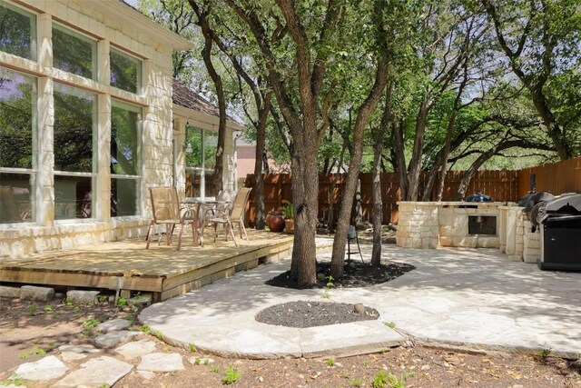 7921 Davis Mountain Pass, Austin, TX 78726 - fenced backyard with area for grilling, a wooden deck, outdoor dining area, and a patio area