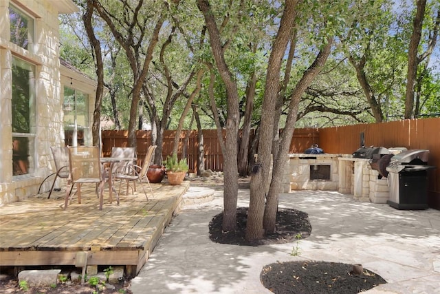 7921 Davis Mountain Pass, Austin, TX 78726 - fenced backyard featuring area for grilling, outdoor dining area, a patio, and a wooden deck