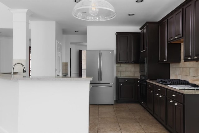 7921 Davis Mountain Pass, Austin, TX 78726 - kitchen with freestanding refrigerator, decorative backsplash, black gas stovetop, built in microwave, and recessed lighting