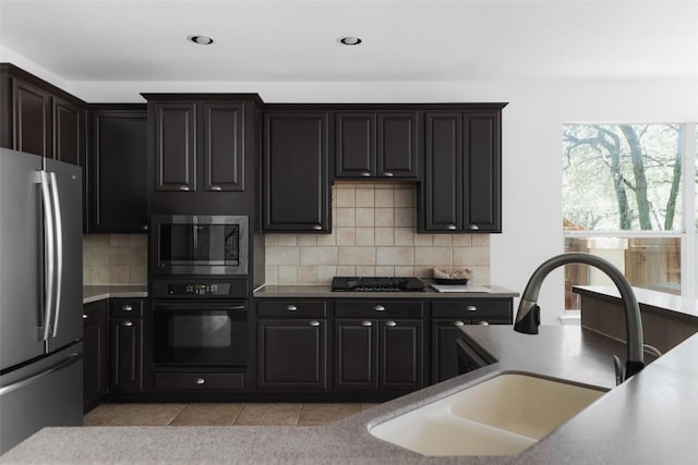 7921 Davis Mountain Pass, Austin, TX 78726 - kitchen with appliances with stainless steel finishes, tasteful backsplash, light tile patterned flooring, light countertops, and recessed lighting
