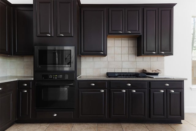 7921 Davis Mountain Pass, Austin, TX 78726 - kitchen with black appliances, light stone countertops, light tile patterned flooring, and tasteful backsplash