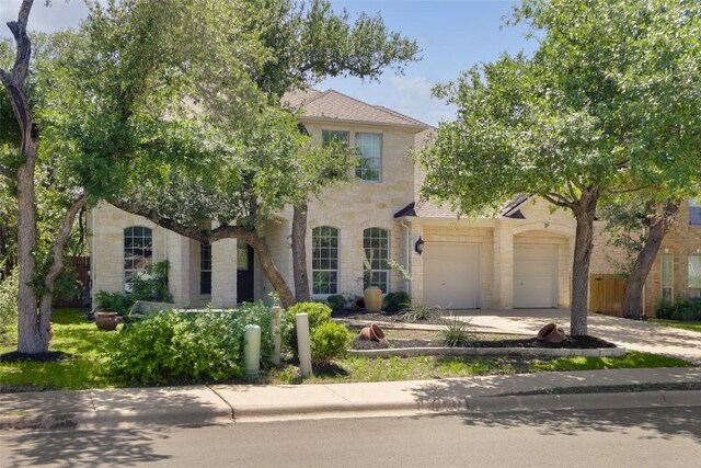 7921 Davis Mountain Pass, Austin, TX 78726 - view of property hidden behind natural elements featuring stone siding and driveway