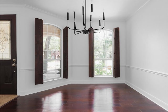 7921 Davis Mountain Pass, Austin, TX 78726 - unfurnished dining area featuring a chandelier, plenty of natural light, wood finished floors, and crown molding