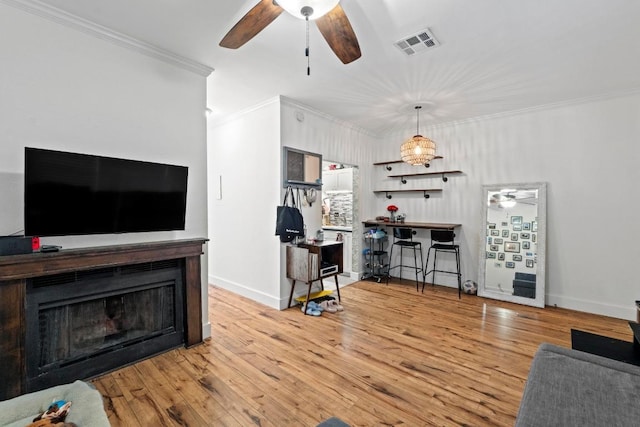 2804 Rio Grande St Unit 206, Austin, TX 78705 - living area with ceiling fan, crown molding, wood finished floors, baseboards, and a fireplace