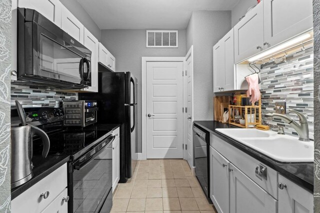 2804 Rio Grande St Unit 206, Austin, TX 78705 - kitchen with black appliances, decorative backsplash, a sink, and dark countertops