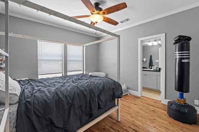 2804 Rio Grande St Unit 206, Austin, TX 78705 - bedroom with ornamental molding, light wood-type flooring, and ensuite bathroom