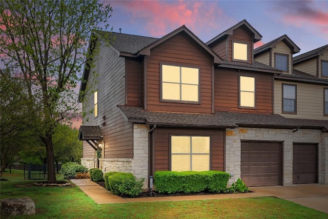11237 Lost Maples Trl, Austin, TX 78748 - multi unit property featuring stone siding, an attached garage, roof with shingles, concrete driveway, and a lawn