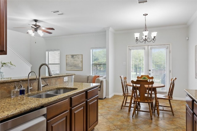 11237 Lost Maples Trl, Austin, TX 78748 - kitchen featuring a sink, a ceiling fan, crown molding, a chandelier, and pendant lighting