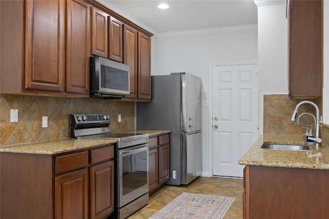 11237 Lost Maples Trl, Austin, TX 78748 - kitchen with stainless steel appliances, a sink, ornamental molding, light stone counters, and decorative backsplash