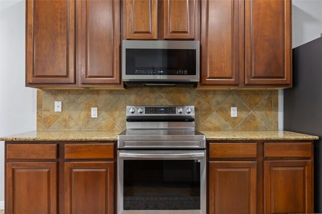 11237 Lost Maples Trl, Austin, TX 78748 - kitchen featuring stainless steel appliances, decorative backsplash, and light stone counters