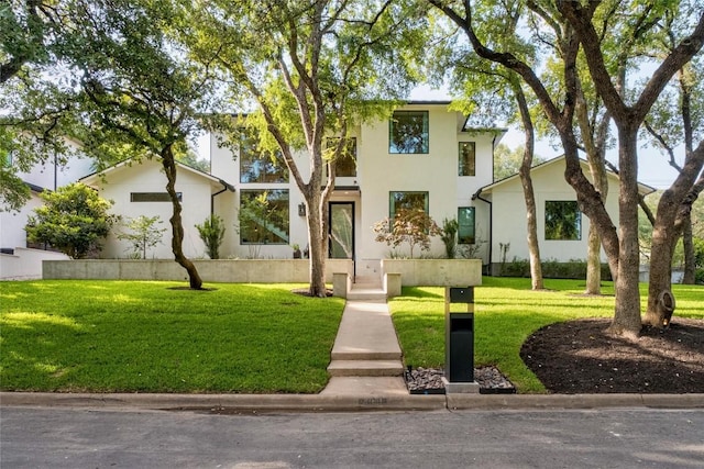 4901 Southcrest Dr, Austin, TX 78746 - contemporary house featuring stucco siding and a front lawn