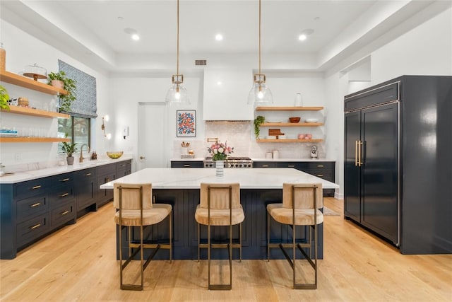 4901 Southcrest Dr, Austin, TX 78746 - kitchen featuring built in fridge, open shelves, light wood-type flooring, tasteful backsplash, and recessed lighting
