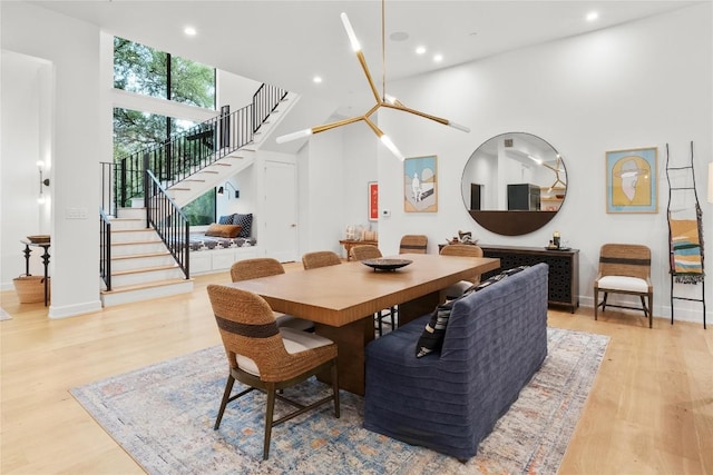 4901 Southcrest Dr, Austin, TX 78746 - dining space with stairs, recessed lighting, light wood-style floors, baseboards, and a towering ceiling