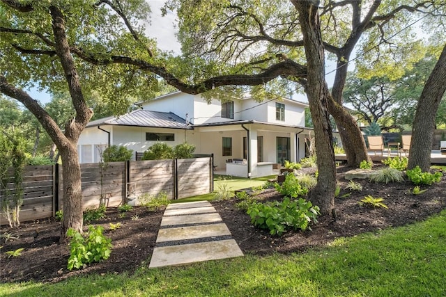 4901 Southcrest Dr, Austin, TX 78746 - back of property featuring stucco siding, metal roof, and a standing seam roof