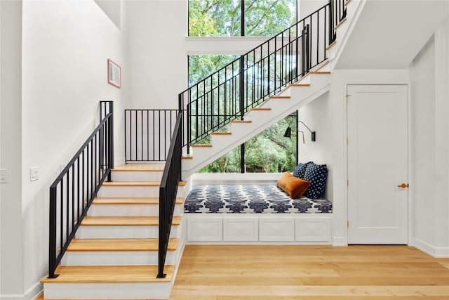 4901 Southcrest Dr, Austin, TX 78746 - staircase with wood finished floors, a high ceiling, and baseboards