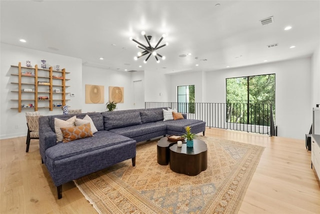4901 Southcrest Dr, Austin, TX 78746 - living room featuring light wood finished floors, a chandelier, and recessed lighting