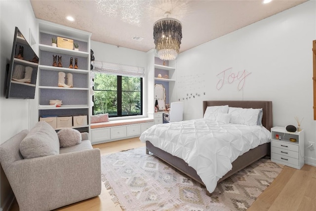 4901 Southcrest Dr, Austin, TX 78746 - bedroom featuring light wood-type flooring, a chandelier, and recessed lighting