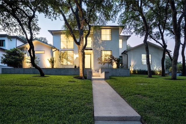 4901 Southcrest Dr, Austin, TX 78746 - view of front of property with stucco siding and a front lawn