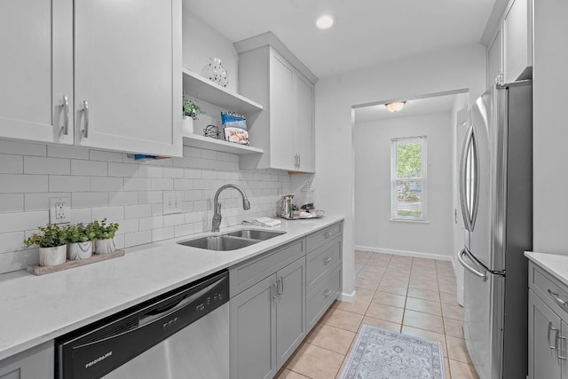 2804 Bushnell Dr, Austin, TX 78745 - kitchen featuring appliances with stainless steel finishes, tasteful backsplash, gray cabinetry, light tile patterned floors, and open shelves