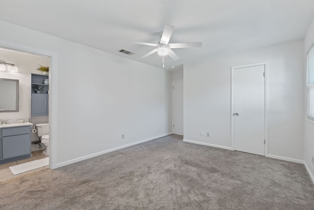 2804 Bushnell Dr, Austin, TX 78745 - unfurnished bedroom featuring carpet floors, ensuite bathroom, and baseboards
