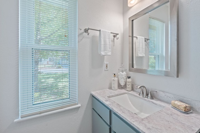 2804 Bushnell Dr, Austin, TX 78745 - bathroom featuring vanity, plenty of natural light, and a textured wall
