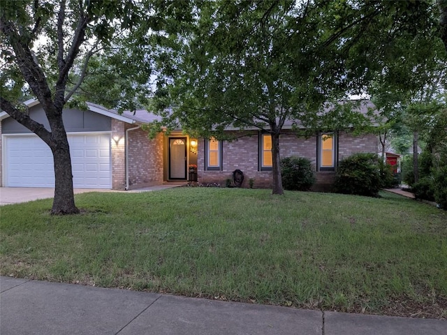 2804 Bushnell Dr, Austin, TX 78745 - view of front of house with a garage, driveway, brick siding, and a front lawn