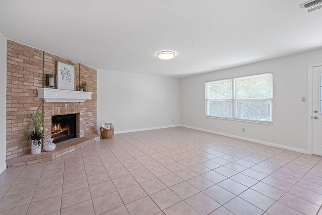 2804 Bushnell Dr, Austin, TX 78745 - unfurnished living room with light tile patterned floors and a fireplace