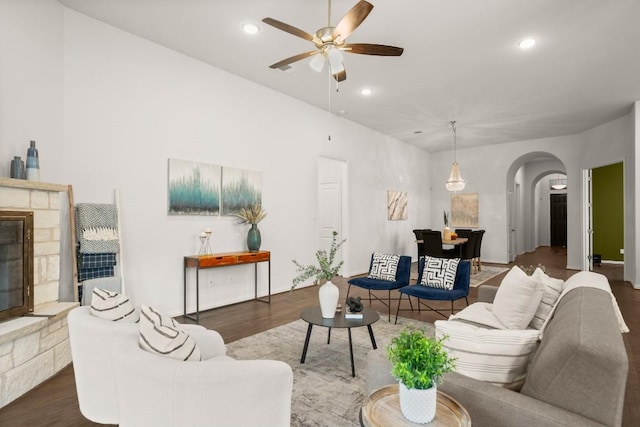 136 Medina Hills Ct, Austin, TX 78737 - living area with arched walkways, wood finished floors, a ceiling fan, a fireplace, and recessed lighting