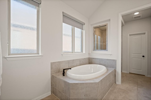 136 Medina Hills Ct, Austin, TX 78737 - full bathroom featuring a bath, tile patterned floors, baseboards, and vaulted ceiling
