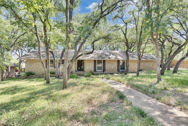 2602 Rollingwood Dr, Rollingwood, TX 78746 - ranch-style home with stone siding and a front yard
