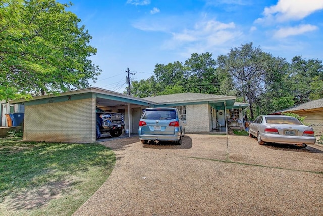 8505 Dryfield Dr, Austin, TX 78758 - view of front of house featuring brick siding, concrete driveway, and a front yard