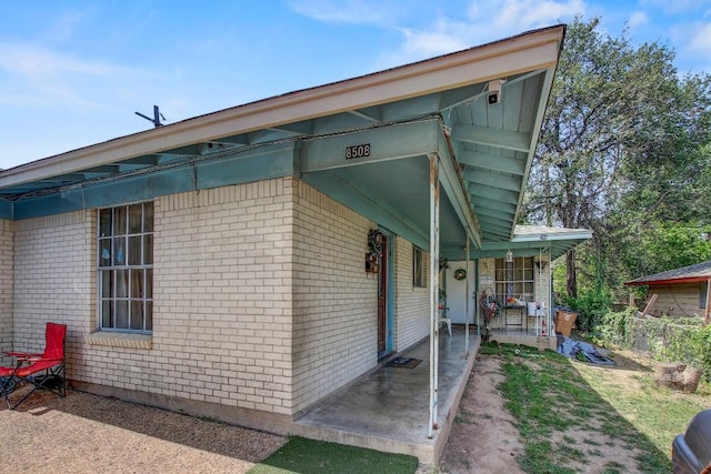 8505 Dryfield Dr, Austin, TX 78758 - view of side of property with brick siding and a porch