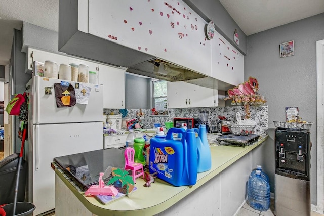 8505 Dryfield Dr, Austin, TX 78758 - kitchen with freestanding refrigerator, white cabinets, and tasteful backsplash