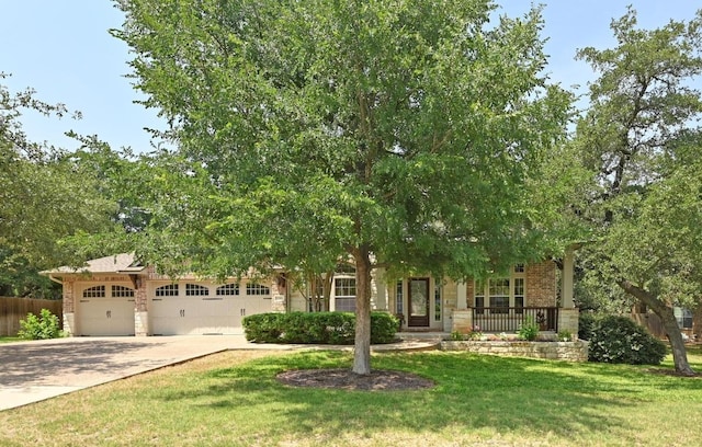 12304 Buvana Dr, Austin, TX 78739 - obstructed view of property with concrete driveway, brick siding, an attached garage, stone siding, and a porch