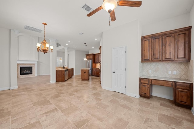 12304 Buvana Dr, Austin, TX 78739 - kitchen featuring open floor plan, a ceiling fan, baseboards, tasteful backsplash, and a sink