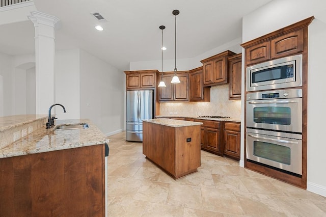 12304 Buvana Dr, Austin, TX 78739 - kitchen featuring appliances with stainless steel finishes, a sink, a center island, baseboards, and recessed lighting